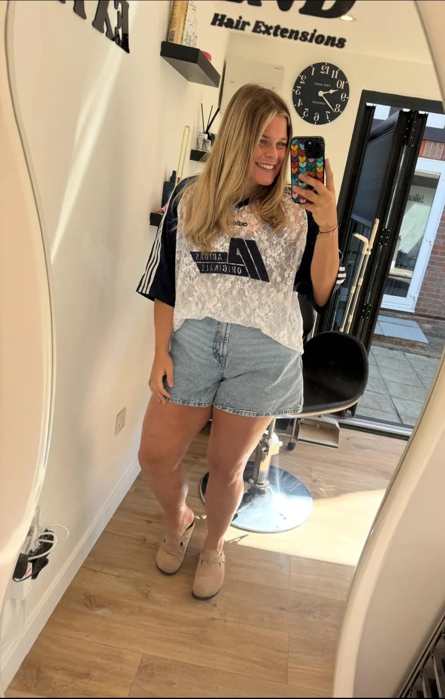 Connie Powell taking a mirror selfie in her salon